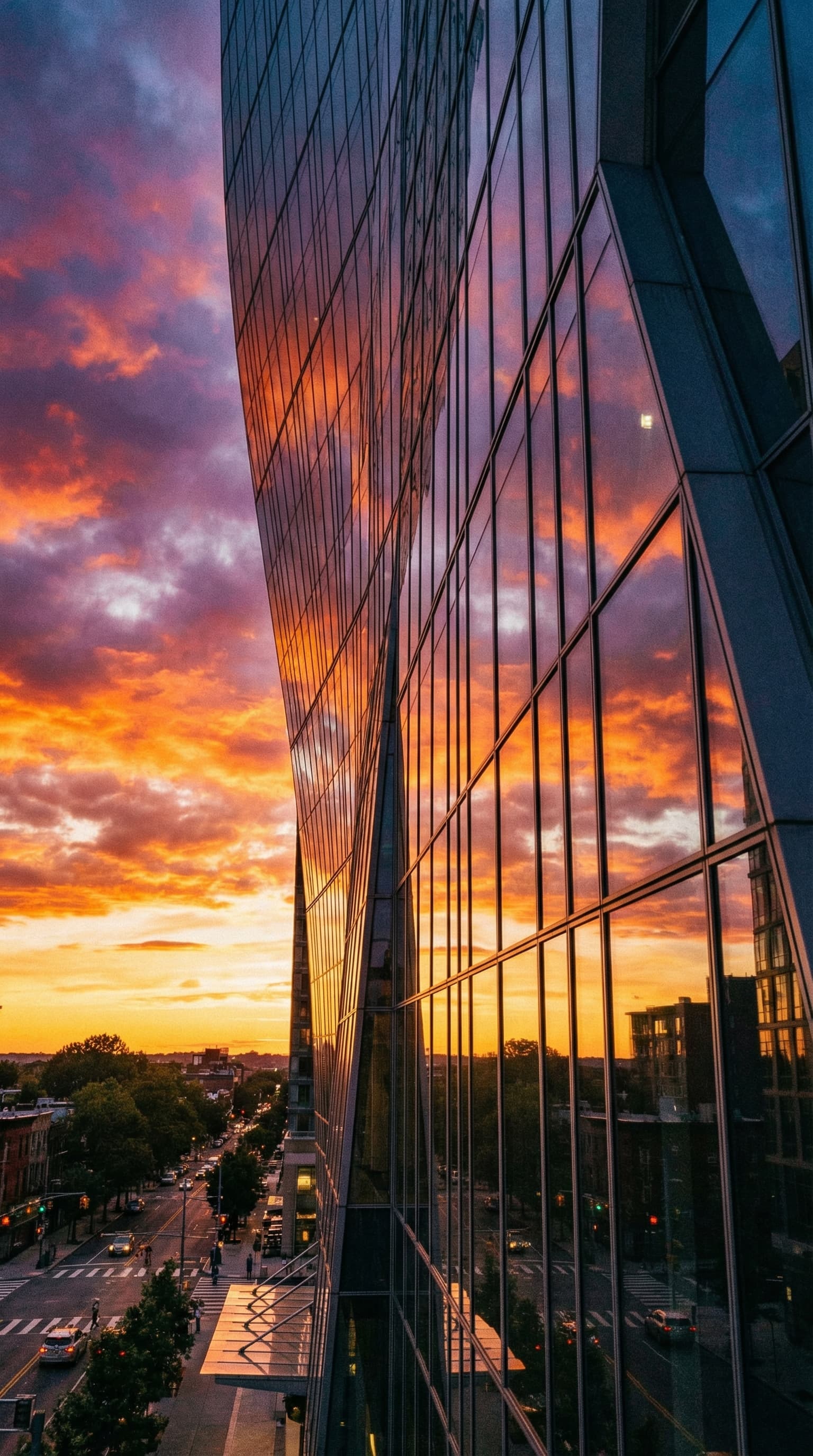 A stunning modern glass skyscraper reflecting sunset clouds, dramatic low angle perspective, architectural photography, sharp details throughout
